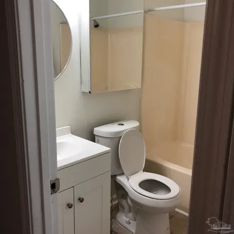 a white toilet sitting next to a bathroom sink
