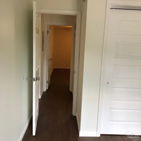 a view of a hallway with a small yard