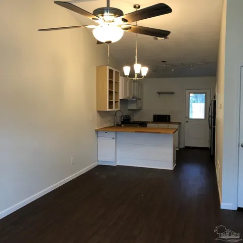 a room with hard wood floors and a chandelier