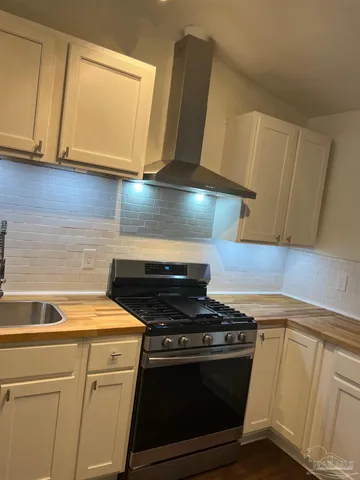 a kitchen with a stove microwave and sink