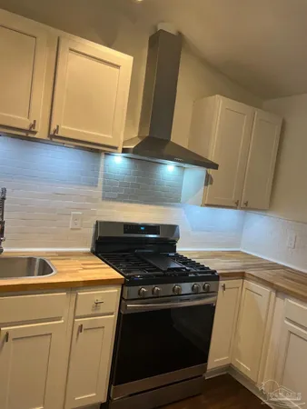 a kitchen with a stove microwave and sink