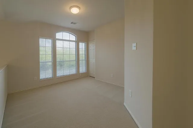 an empty room with windows and closet
