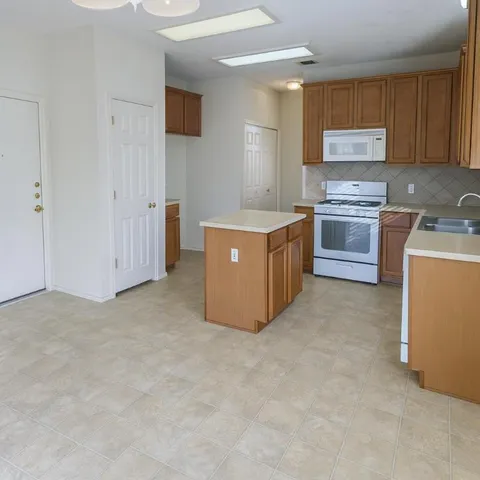 a kitchen with stainless steel appliances a stove top oven