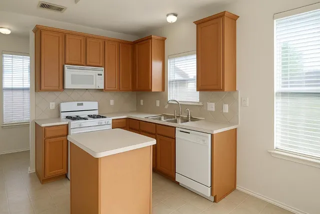 a kitchen with a sink stove and cabinets