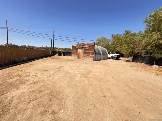 a large white bed in a field next to a road
