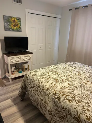 a bathroom with a granite countertop sink a mirror and a shower