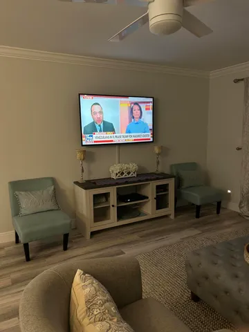 a bedroom with a bed and a ceiling fan