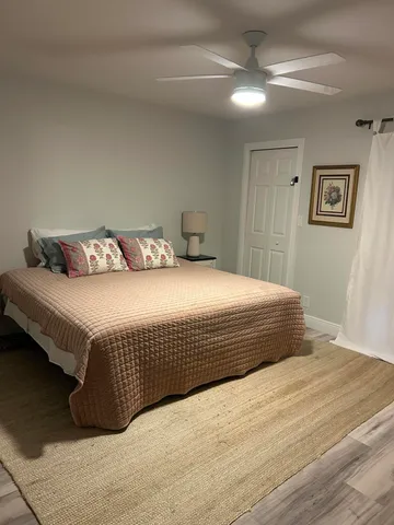 a bedroom with bed and a flat screen tv