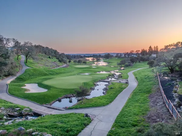 a view of a garden with a building in the background
