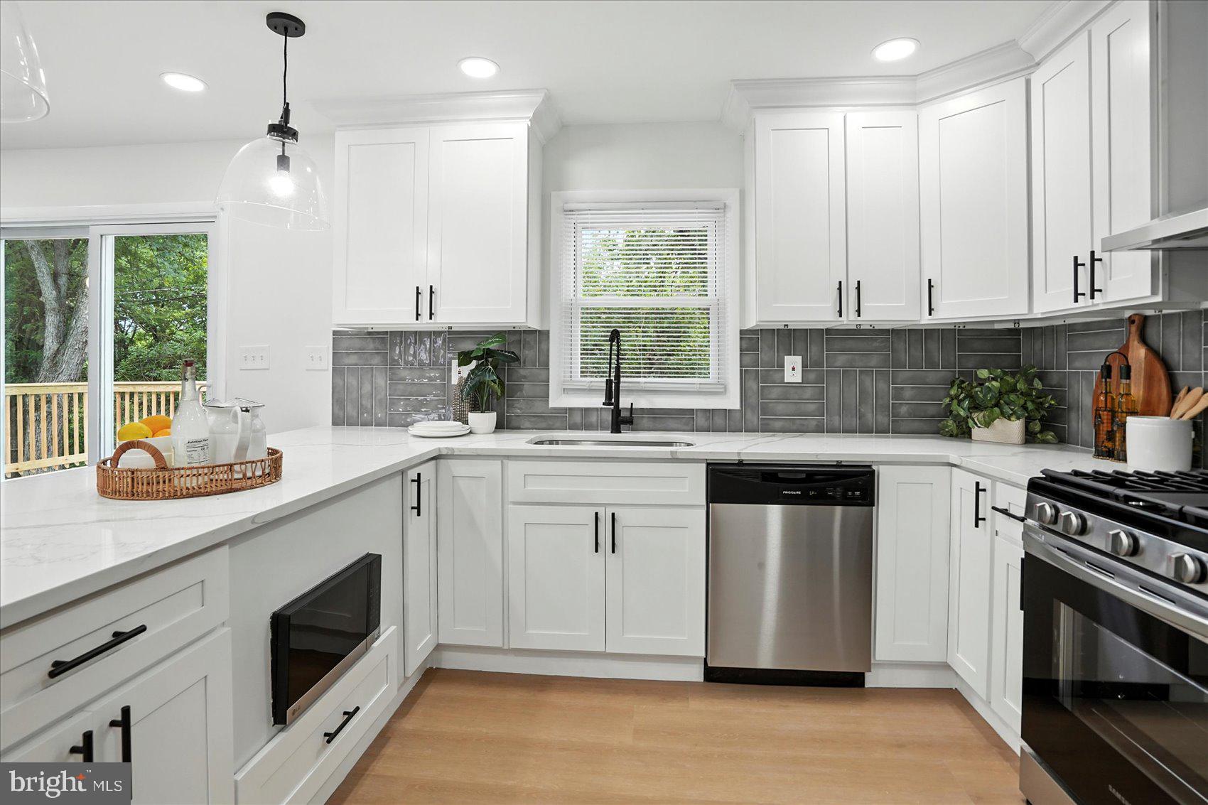 7031 Glen Spring Road Baltimore, MD 21244 - Photo 13 of 43 a kitchen with stainless steel appliances granite countertop a stove a sink and a refrigerator