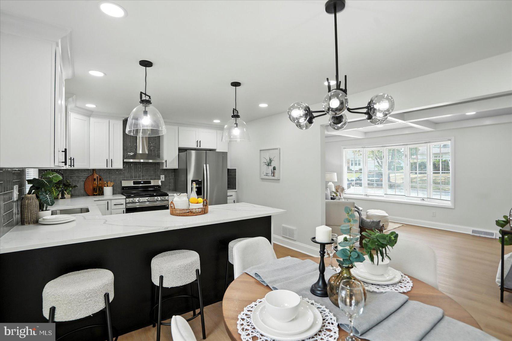 7031 Glen Spring Road Baltimore, MD 21244 - Photo 15 of 43 a dining room with furniture a chandelier and wooden floor