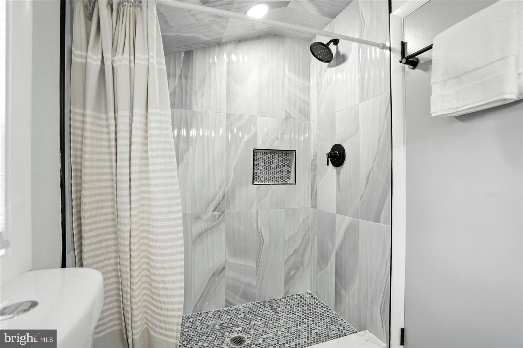 7031 Glen Spring Road Baltimore, MD 21244 - Photo 20 of 43 a bathroom with a shower