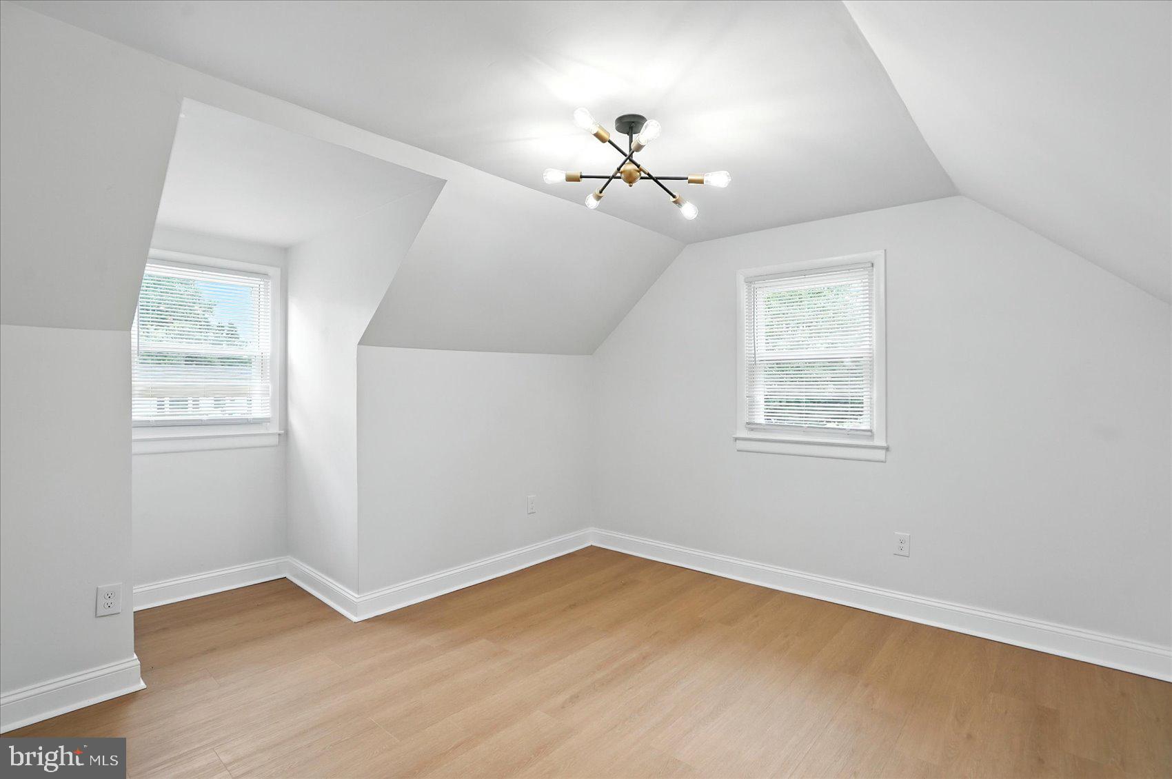 7031 Glen Spring Road Baltimore, MD 21244 - Photo 23 of 43 wooden floor in an empty room with a window
