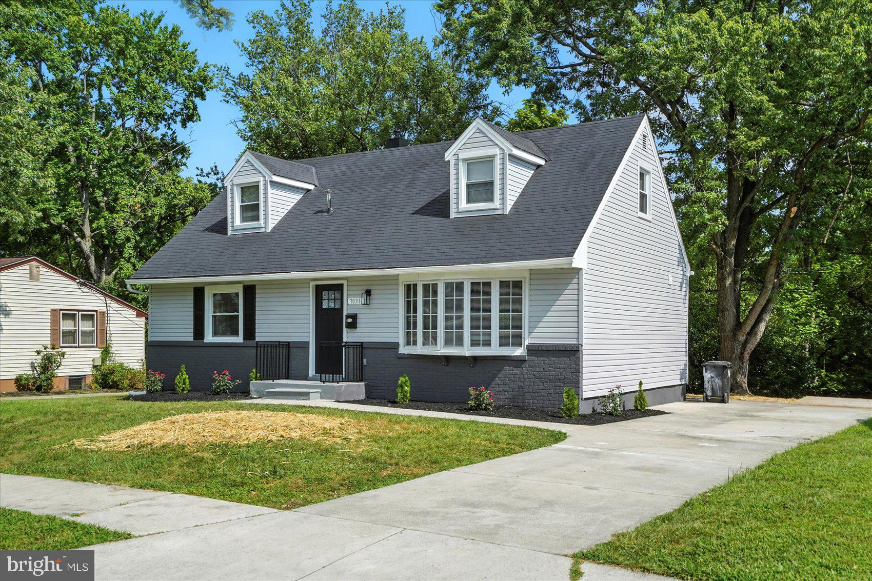 7031 Glen Spring Road Baltimore, MD 21244 - Photo 4 of 43 a front view of a house with a yard and garage