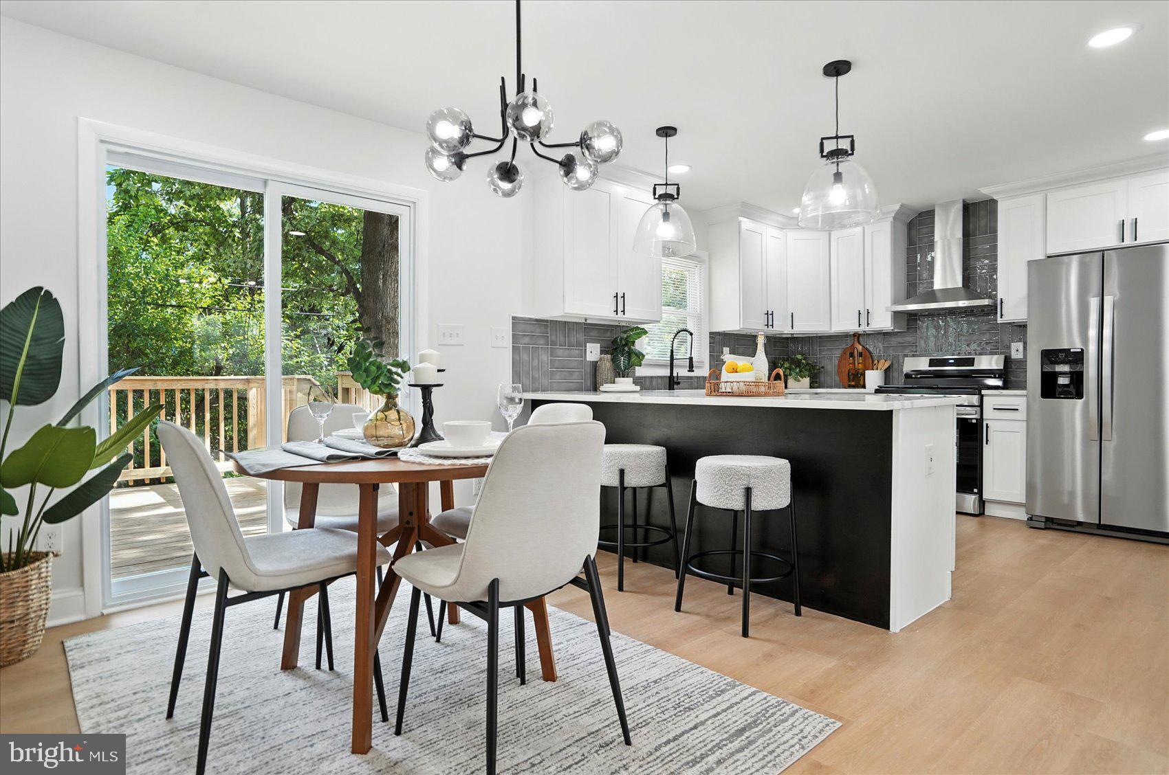 7031 Glen Spring Road Baltimore, MD 21244 - Photo 8 of 43 a dining room with furniture a chandelier and wooden floor