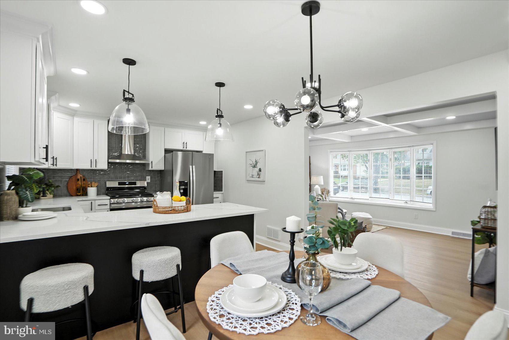 7031 Glen Spring Road Baltimore, MD 21244 - Photo 10 of 43 a dining room with wooden floor a chandelier a glass table and chairs