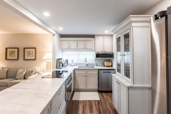 a kitchen with stainless steel appliances granite countertop a refrigerator and a sink