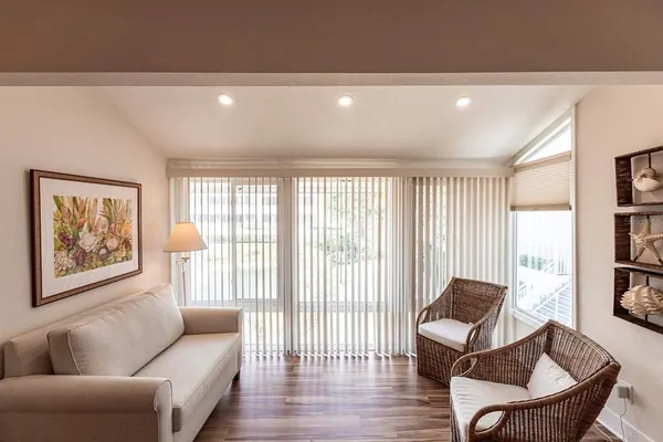 a living room with furniture and a book shelf
