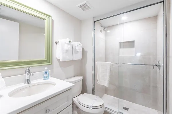 a bathroom with a sink toilet and shower