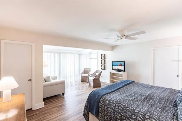 a bedroom with a bed and wooden floor
