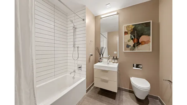 a bathroom with a toilet a sink and bathtub