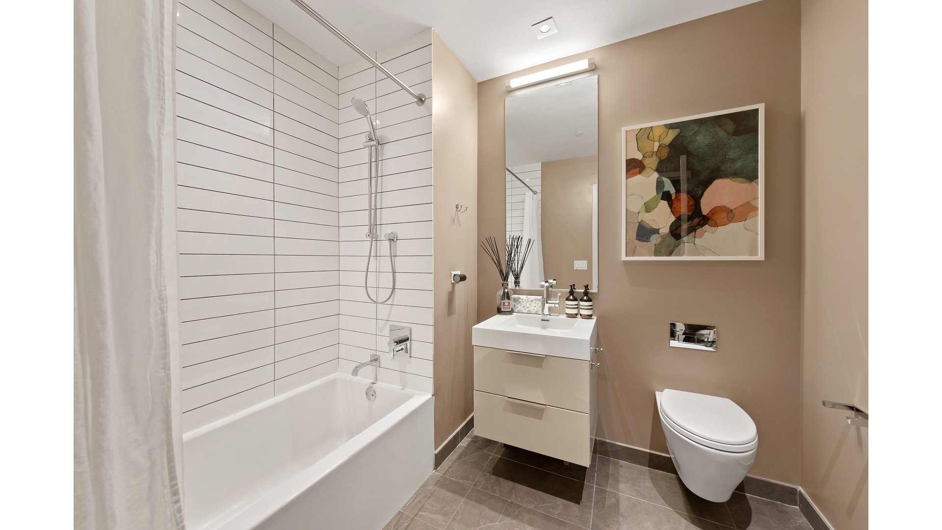 101 Leonard Street, Unit 5F Manhattan, NY 10013 - Photo 4 of 9 a bathroom with a toilet a sink and bathtub