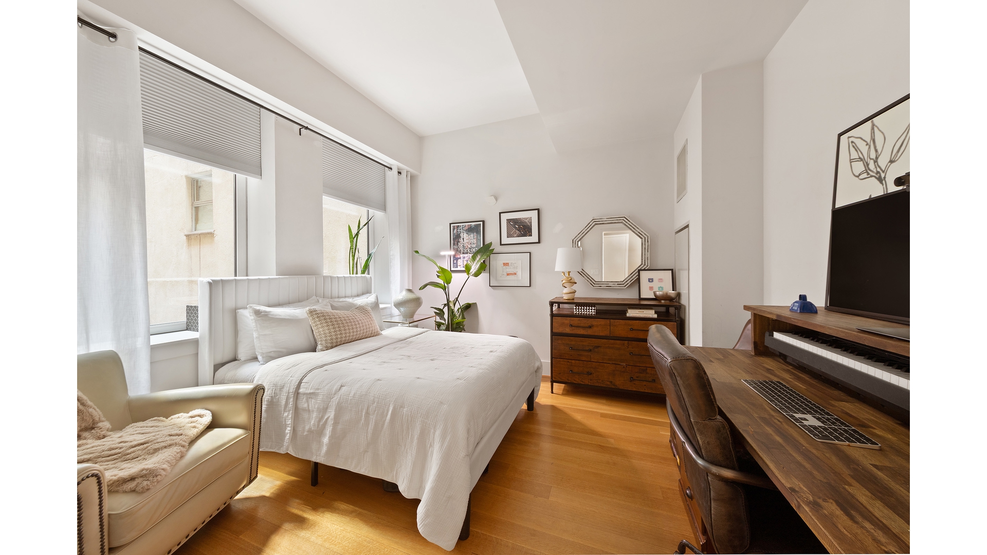 101 Leonard Street, Unit 5F Manhattan, NY 10013 - Photo 5 of 9 a bedroom with bed and a couch