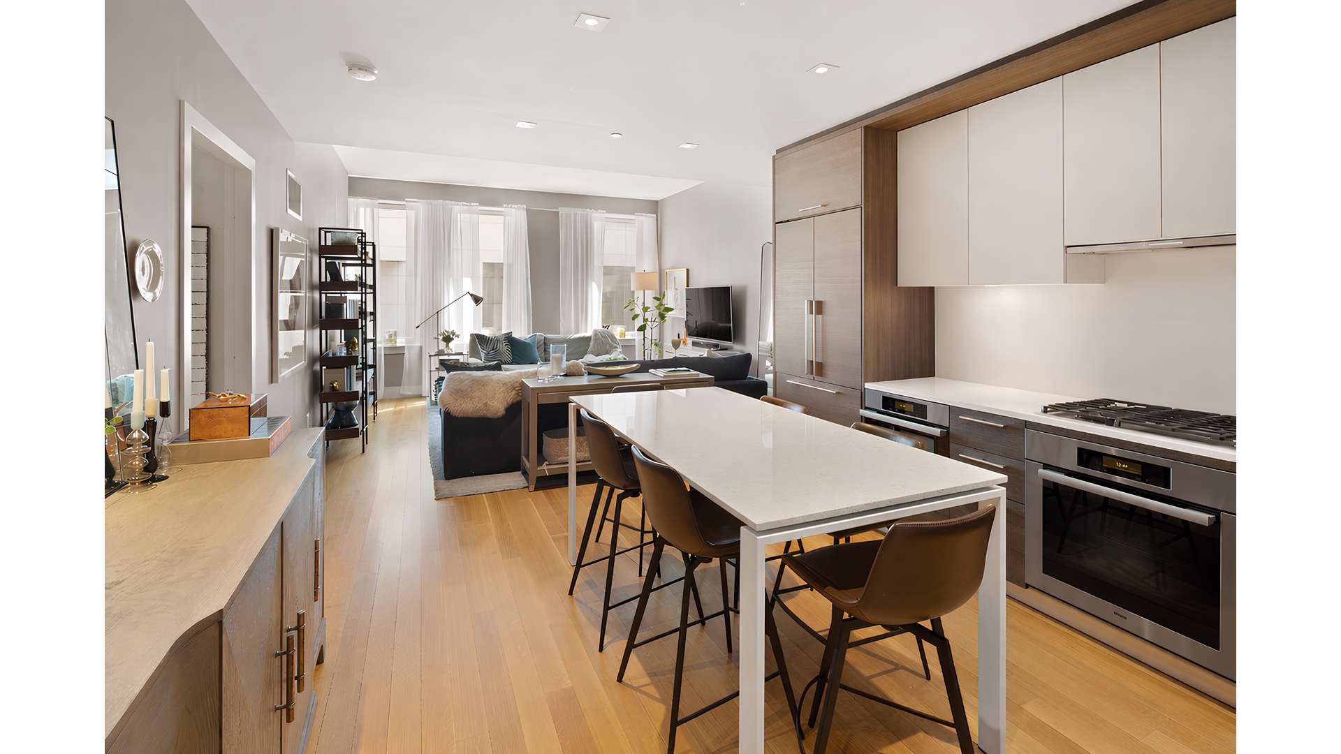 101 Leonard Street, Unit 5F Manhattan, NY 10013 - Photo 8 of 9 a open kitchen with stainless steel appliances granite countertop a stove a refrigerator a dining table and chairs with wooden floor