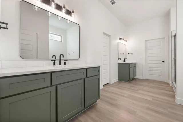a spacious bathroom with a double vanity sink mirror and
