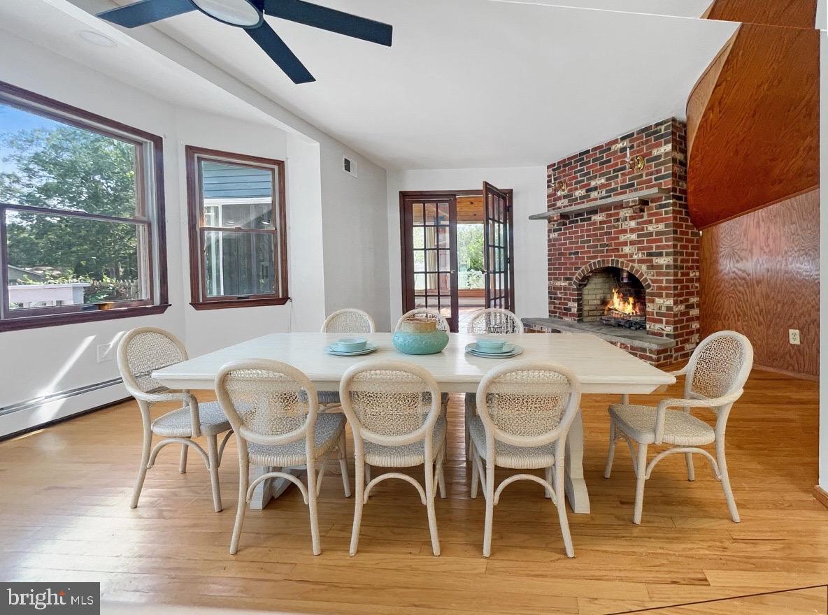 705 Princeton Road Lanoka Harbor, NJ 08734 - Photo 21 of 141 a dining room with furniture a fireplace and wooden floor