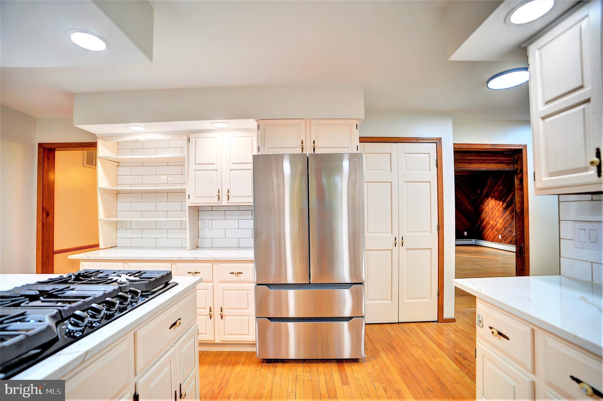 705 Princeton Road Lanoka Harbor, NJ 08734 - Photo 43 of 141 a kitchen with stainless steel appliances granite countertop a refrigerator and a stove top oven