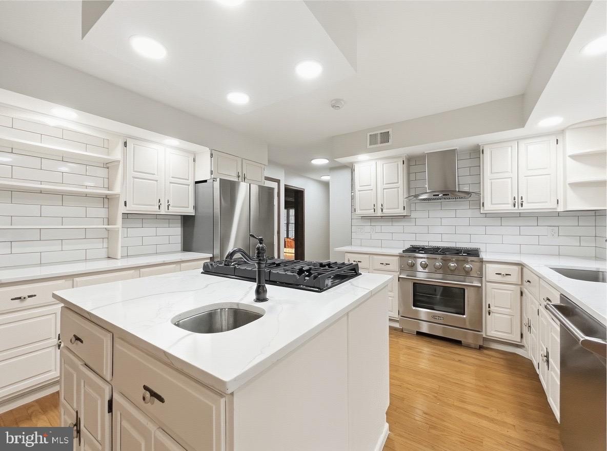 705 Princeton Road Lanoka Harbor, NJ 08734 - Photo 59 of 141 a kitchen with a sink stove and cabinets
