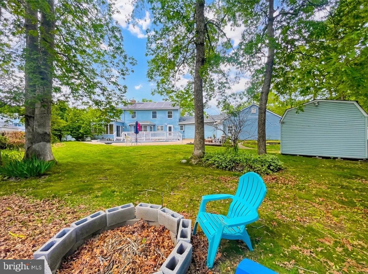 705 Princeton Road Lanoka Harbor, NJ 08734 - Photo 7 of 141 a view of a swimming pool with a garden and seating area