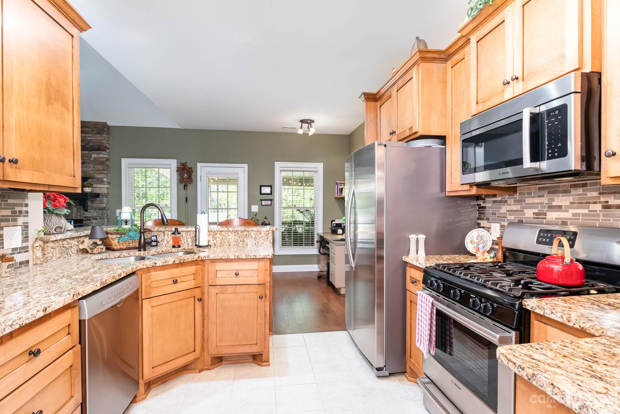 2255 South Paraham Road York, SC 29745 - Photo 7 of 33 a kitchen with stainless steel appliances granite countertop a stove top oven a sink dishwasher and cabinets with wooden floor