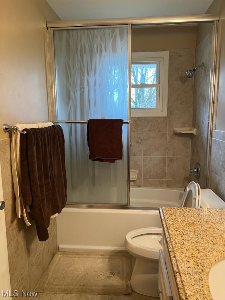 932 Pinecrest Road Girard, OH 44420 - Photo 16 of 25 Full bathroom featuring shower / bath combination with glass door, toilet, and vanity