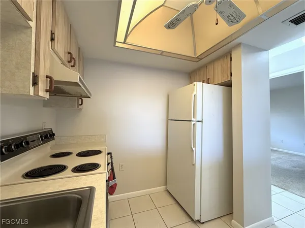 a kitchen with stainless steel appliances a refrigerator and a stove top oven