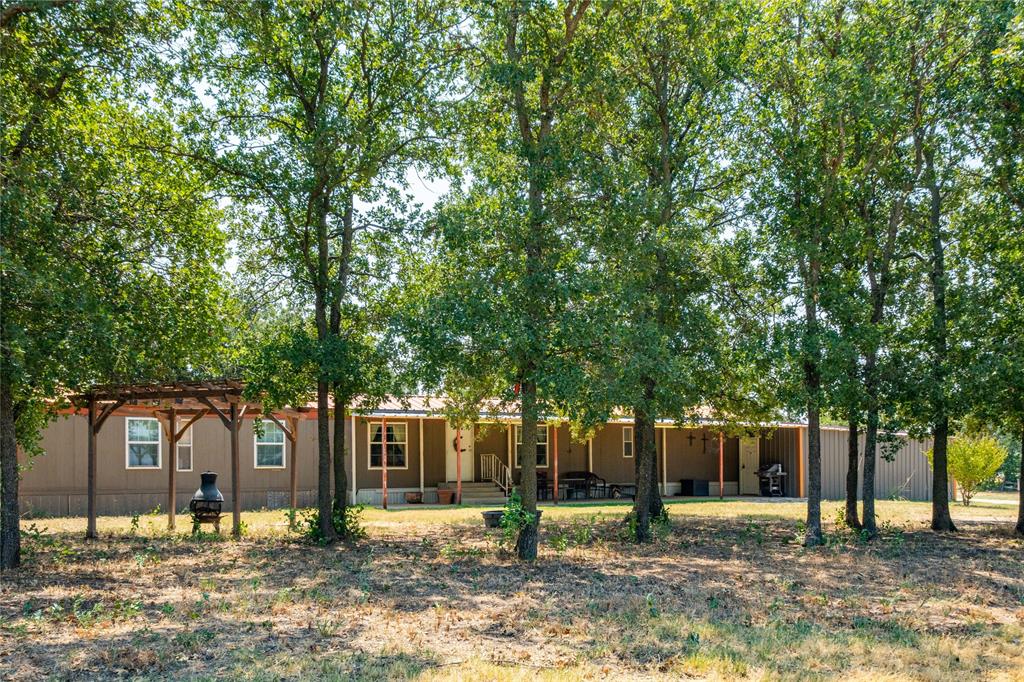 2588 County Road 283 Baird, TX 79504 - Photo 1 of 1 a tree in front of a white house