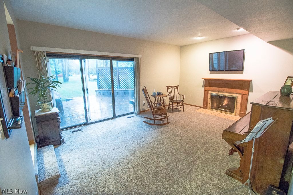 8737 Hendricks Road Mentor, OH 44060 - Photo 8 of 33 Family room with fireplace and sliding doors leading to large deck