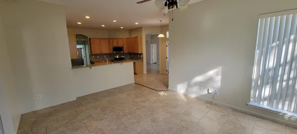 a view of kitchen with stainless steel appliances refrigerator and window