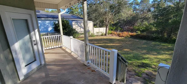 a view of a porch with a small yard