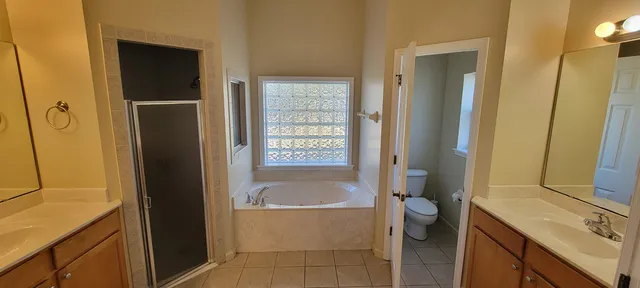 a bathroom with a tub sink and mirror