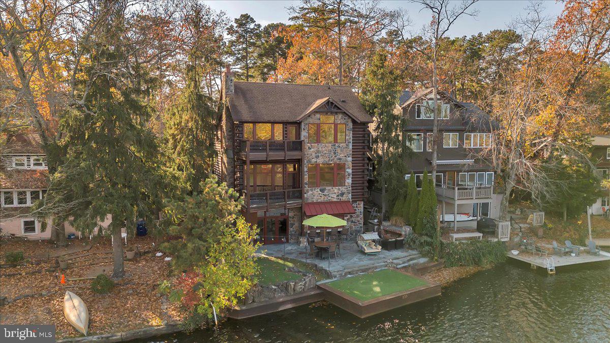 a view of a house with yard and sitting area
