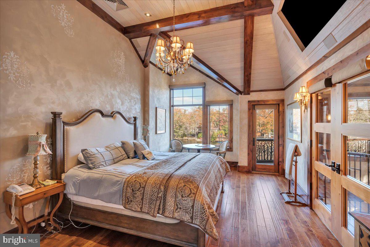 133 Stokes Road Medford Lakes, NJ 08055 - Photo 31 of 57 a bedroom with a large bed and a large window with wooden floor