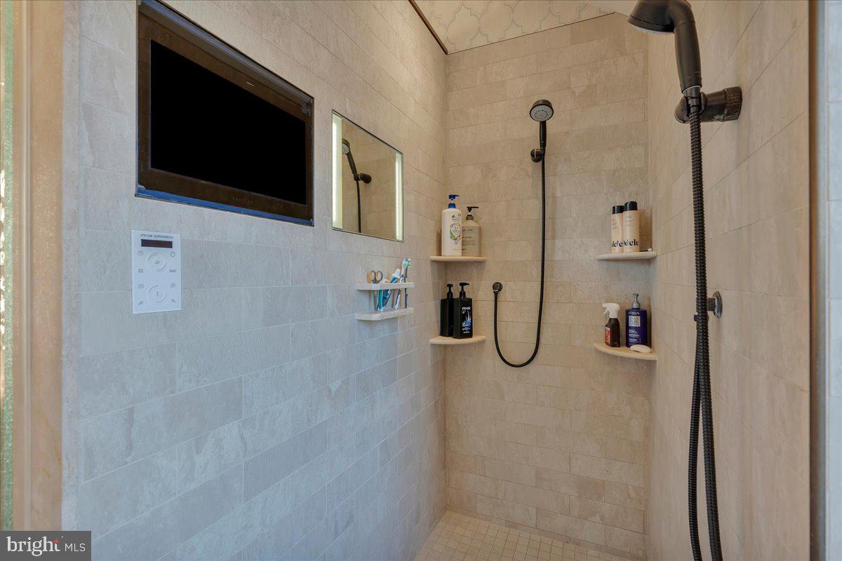 133 Stokes Road Medford Lakes, NJ 08055 - Photo 34 of 57 a bathroom with a granite countertop shower and a flat screen tv