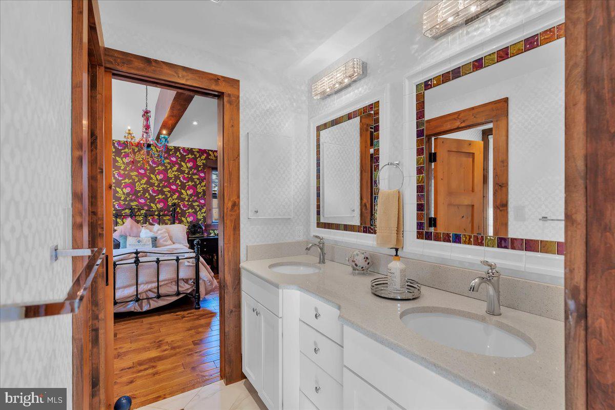 133 Stokes Road Medford Lakes, NJ 08055 - Photo 38 of 57 a en suite bathroom with a double vanity sink and a mirror