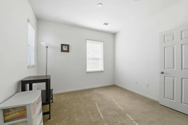 a view of a livingroom with a chair and a window