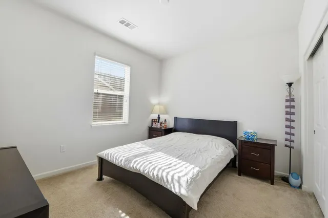 a bedroom with a bed and a night stand