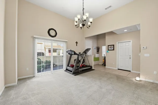 a dining room with furniture and a floor to ceiling window