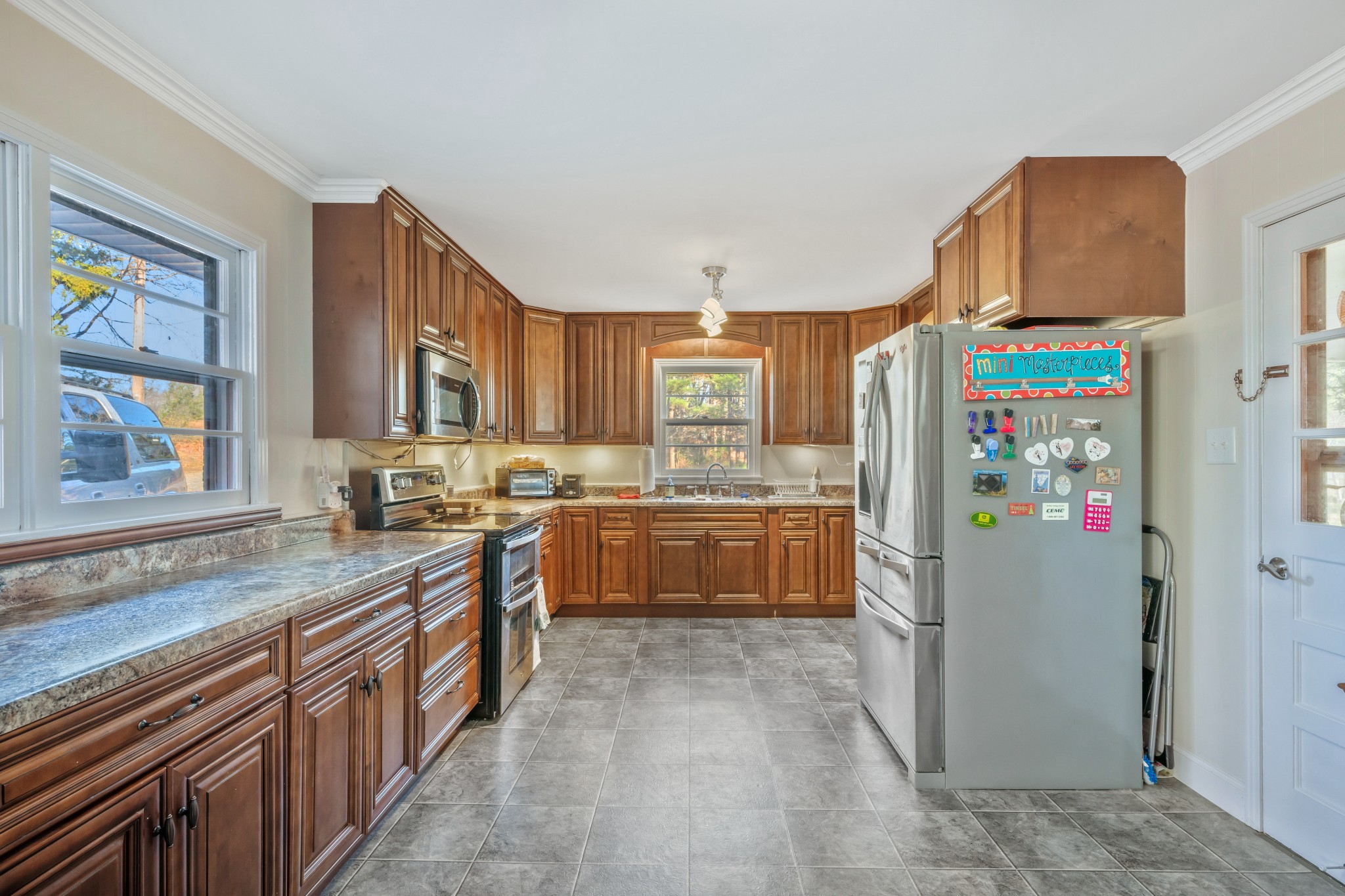 1555 Highway 13 Cunningham, TN 37052 - Photo 11 of 30 a kitchen with stainless steel appliances granite countertop a refrigerator and a stove