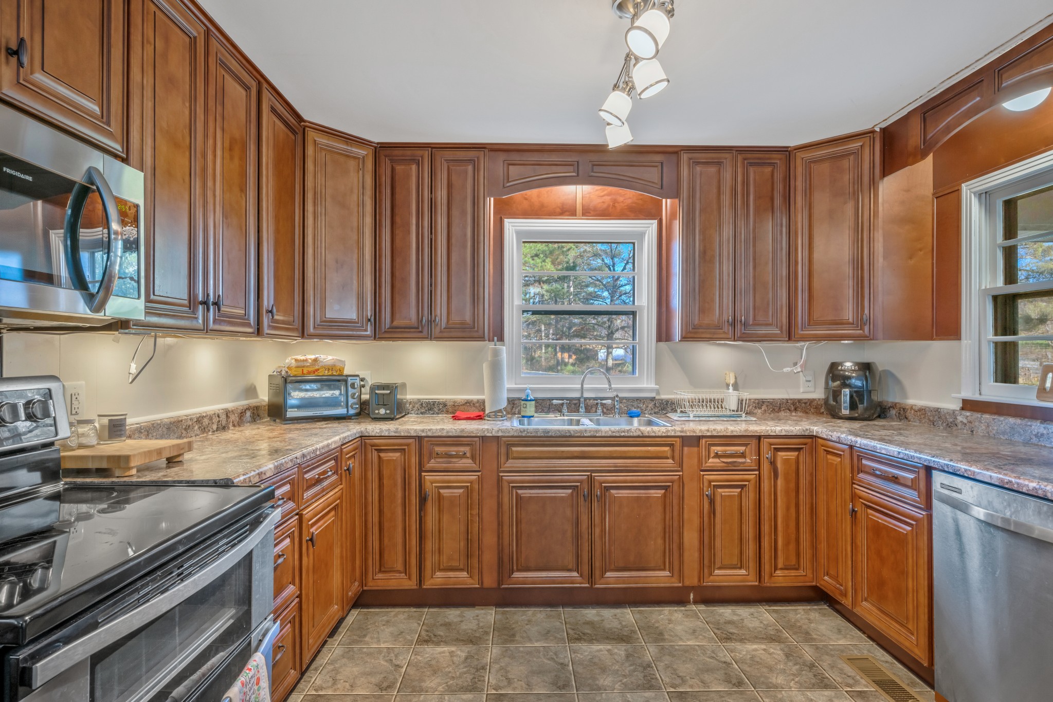 1555 Highway 13 Cunningham, TN 37052 - Photo 12 of 30 a kitchen with a sink stove and cabinets